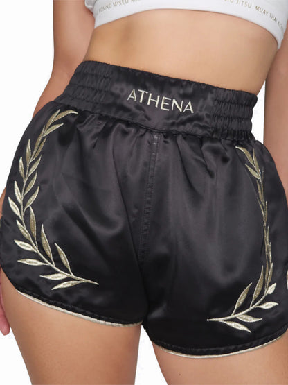 Athena Damen Muay Thai Shorts in Schwarz/Gold, speziell für weibliche Körperform, Ansicht vorne